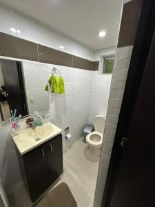 a bathroom with a sink and a toilet at Casa en Marinilla cerca a guatape y el peñol in Marinilla