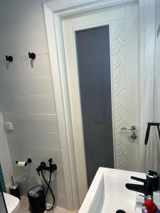 a bathroom with a shower and a white sink at Luxurious apartment Lina in Hiboun +27 photos