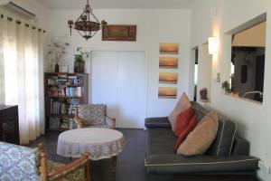 a living room with a couch and a table at Sea View Urban Oasis in Tel Aviv