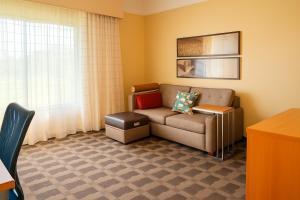 a living room with a couch and a table at TownePlace Suites by Marriott Hattiesburg in Hattiesburg