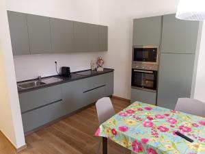 a kitchen with a table and a counter top at Murgia pool retreat in Cassano delle Murge