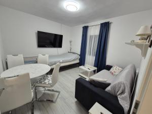 a small living room with a couch and a table at Šućur holiday home in Preko