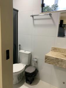 a white bathroom with a toilet and a sink at HOTEL LISBOA in Capanema +52 photos