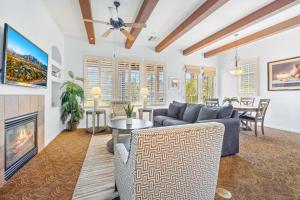 a living room with a couch and a fireplace at LV368 Upstairs 3BR LV Condo with 2 Primary Suites in La Quinta
