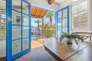 a living room with a wooden table and a sliding glass door at LV368 Upstairs 3BR LV Condo with 2 Primary Suites in La Quinta