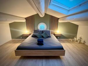 a bedroom with a large bed with a window at Villa Opaline in Issirac +50 photos