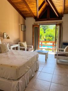 a bedroom with a large bed and a large window at Posada Shemak in Villa General Belgrano +54 photos