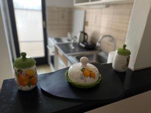 a kitchen counter with two vases with fruit on them at Centar Sweet Home in Šabac