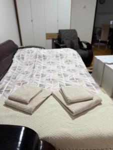 a bed with two pillows on top of it at Centar Sweet Home in Šabac