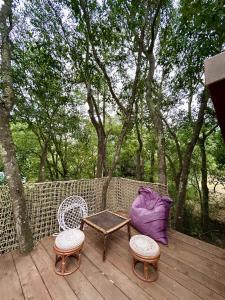 a table and two chairs on a wooden deck at Gite tente LOTUS in Montesquieu +10 photos