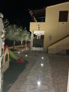a house with a play yard at night at Villaluciana Solanas in Solanas +43 photos