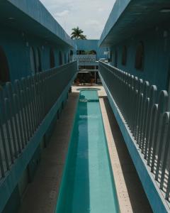 a swimming pool on a building with blue walls at Casa Amate 62 - Mérida centro in Mérida +66 photos