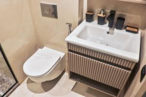 a bathroom with a white toilet and a sink at Studio de charme face corniche de Casablanca in Casablanca +32 photos