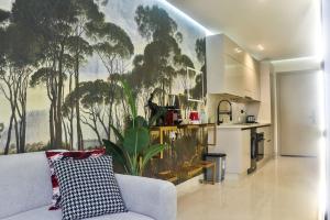 a living room with a couch and a kitchen at Studio de charme face corniche de Casablanca in Casablanca