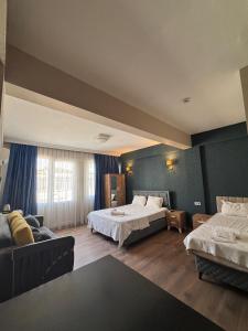 a hotel room with two beds and a couch at DUUM suite in Karşıyaka