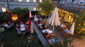 a group of people sitting at tables with umbrellas at Karpfenhotel & Herrenhaus im Gasthaus Sindel-Buckel in Feuchtwangen +11 photos