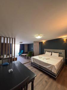 a bedroom with a bed and a table in it at DUUM suite in Karşıyaka +11 photos