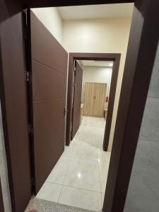 a hallway with a hallway leading to a room with cabinets at غرفة وحمام مفروشة in Riyadh