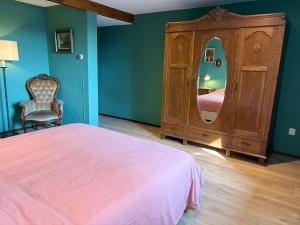 a bedroom with a bed and a dresser with a mirror at Cadier and Keer 1926 in Cadier en Keer