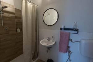 a bathroom with a sink and a mirror and a shower at Casa Febe in Gombio +12 photos