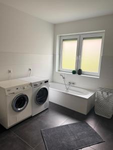 a bathroom with a washing machine and a sink at Zentral & Ruhig - Apartment für 6 Gäste in Top Lage! in Königswinter