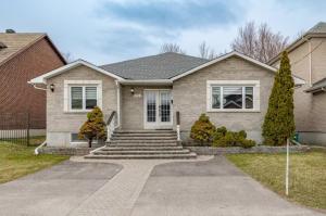 a house with a staircase leading to the front door at Bungalow Home in Ottawa