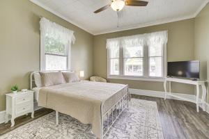 a bedroom with a bed and a flat screen tv at Walk to Restaurants and Shops Dtwn Franklin Retreat in Franklin