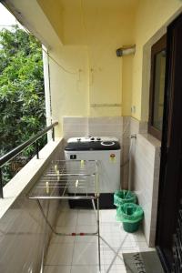 a stove sitting on a balcony with a table at 2 Bedroom Family apartment in cooke town in Bengaluru
