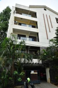 a person on a bike in front of a building at 2 Bedroom Family apartment in cooke town in Bengaluru