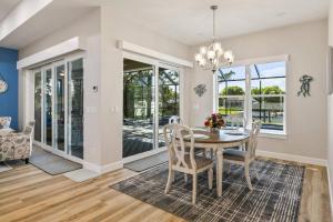 a dining room with a table and chairs at Coastal Paradise Waterfront Pool Home in Bon Terra +42 photos