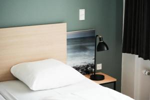 Postel nebo postele na pokoji v ubytování Hotel Nørherredhus