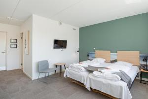 Postel nebo postele na pokoji v ubytování Hotel Nørherredhus