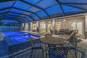 a swimming pool with chairs and a table and a pool at Coastal Paradise Waterfront Pool Home in Bon Terra