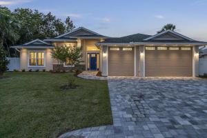 a modern house with a garage at Coastal Paradise Waterfront Pool Home in Bon Terra
