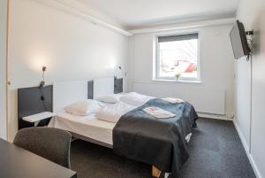 Postel nebo postele na pokoji v ubytování Hotel Nørherredhus