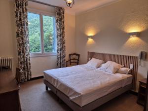 Postel nebo postele na pokoji v ubytování Hôtel Val Du Tech