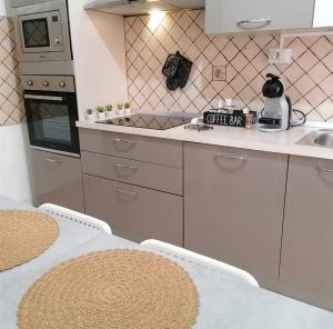 a kitchen with a table and a stove top oven at Teresa Daina Casa dolce casa in Siculiana
