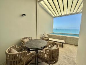 a dining room with a table and chairs and the ocean at Zantamar PH608B, frente al mar in Cruz de Huanacaxtle +3 photos