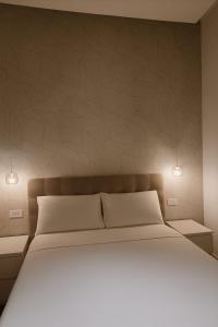 a bedroom with a large bed with white pillows at De Angelis Apartments - GOLD in Sant'Agnello