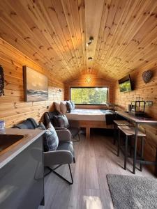 a living room with a couch and a table at River Huts with Private Hot Tubs in Inverness