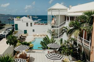 a view of a building with umbrellas and a swimming pool at King Christian Hotel in Christiansted