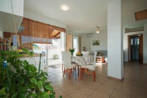 a kitchen and dining room with a table and chairs at Apartments Kamenar in Klimno