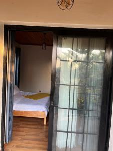 a bedroom with a bed and a glass door at Ecolux rebero residence in Kigali