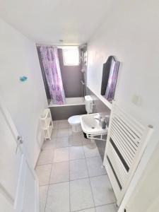 a white bathroom with a toilet and a sink at Vila Toscana in Eforie Nord +14 photos