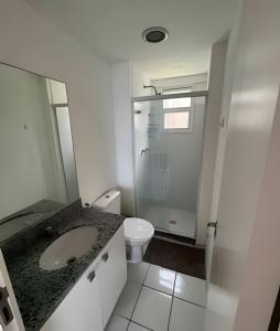 a white bathroom with a sink and a toilet at PORTO REAL RESORT - APARTAMENTO VISTA MAR EM CONDOMÍNIO COM PRAIA PRIVATIVA in Mangaratiba