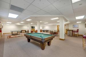 a pool table in a room with tables and chairs at Walk to Main Street Hot Tub Gym and Game Room in Breckenridge
