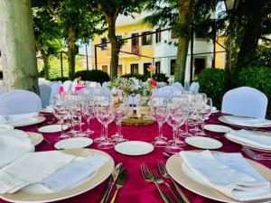 a table with wine glasses and napkins on it at Punta me Palace " Hotel & Private Events " in Guadarrama +105 photos