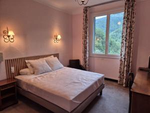 Postel nebo postele na pokoji v ubytování Hôtel Val Du Tech