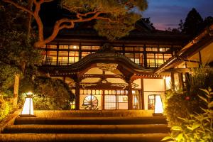a building with stairs in front of it at night at Hakone Kowakien Mikawaya Ryokan in Hakone