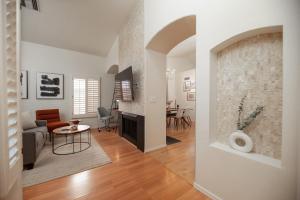 a living room with a couch and a table at Stylish & Sunny With Heated Pool In The Foothills! in Phoenix